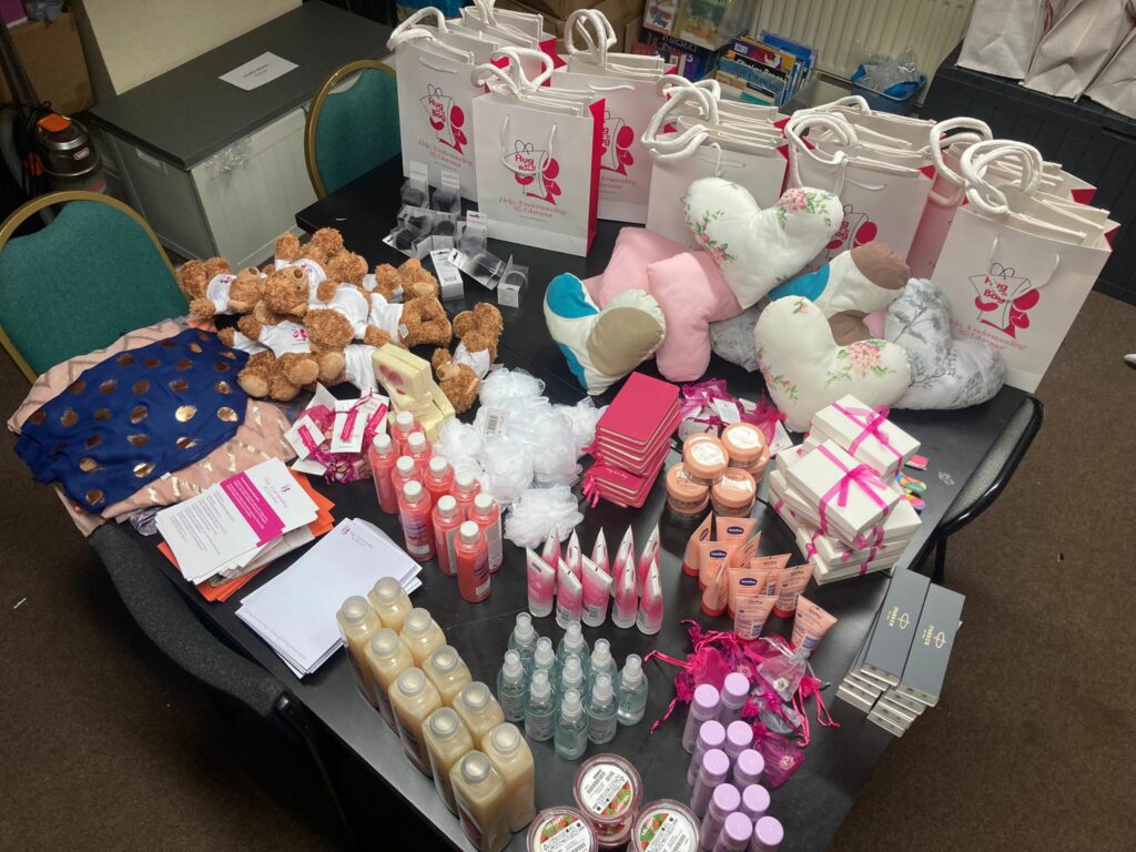 A table with an array or care products, from teddy bears to pillows and hygiene products.