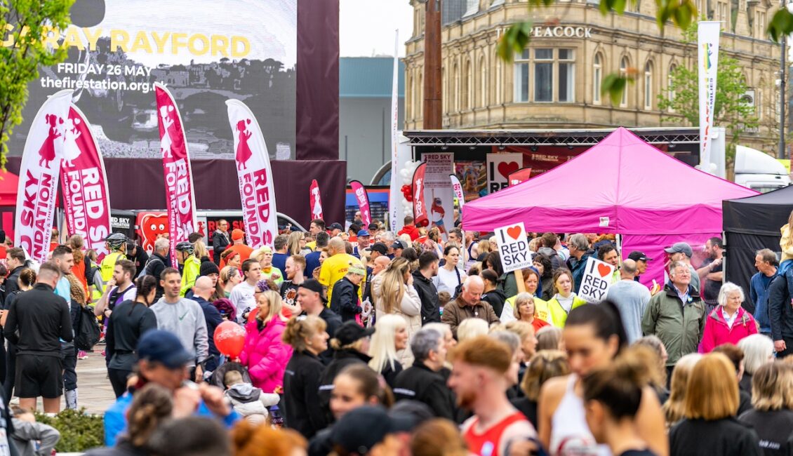 Crowds at Sunderland City Runs. Banners reading Red Sky Foundation in the background.
